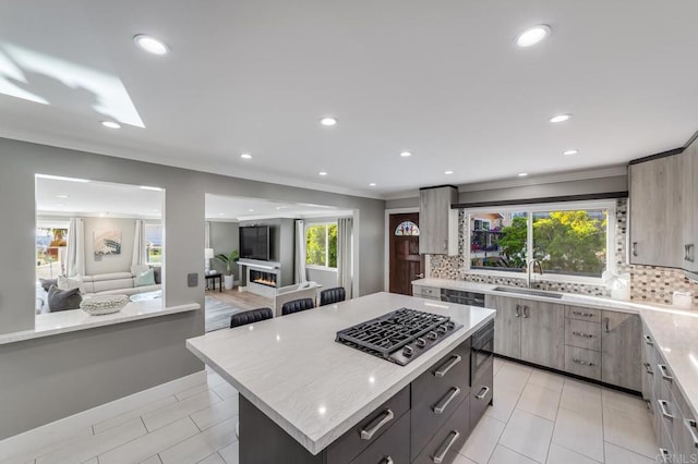 3526 Ticonderoga St, San Diego, CA 92117 - kitchen featuring stainless steel gas stovetop, tasteful backsplash, a kitchen island, recessed lighting, and open floor plan