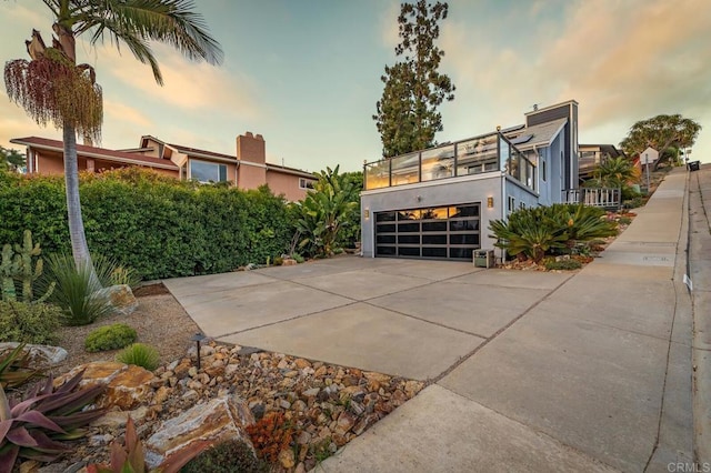 3526 Ticonderoga St, San Diego, CA 92117 - view of property exterior with concrete driveway, a balcony, a garage, and stucco siding