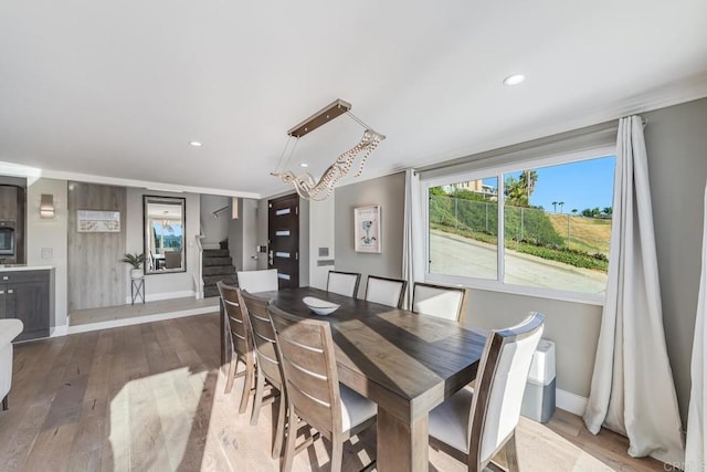 3526 Ticonderoga St, San Diego, CA 92117 - dining room featuring stairs, wood-type flooring, recessed lighting, and crown molding