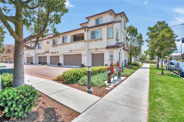 1405 Santa Victoria Rd Unit 2, Chula Vista, CA 91913 - view of front of home featuring driveway, an attached garage, stucco siding, and a residential view