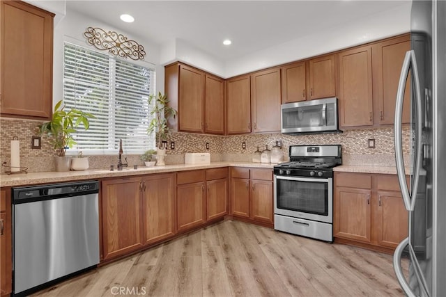 1405 Santa Victoria Rd Unit 2, Chula Vista, CA 91913 - kitchen featuring appliances with stainless steel finishes, light countertops, light wood-type flooring, brown cabinets, and recessed lighting