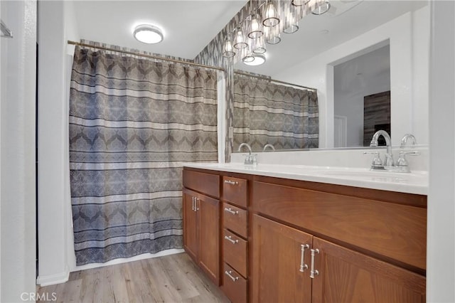 1405 Santa Victoria Rd Unit 2, Chula Vista, CA 91913 - bathroom with double vanity, wood finished floors, and a shower with curtain