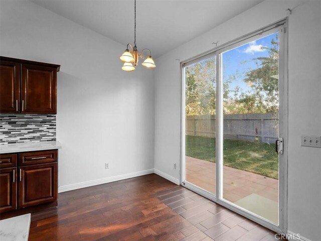 37453 56th St E, Palmdale, CA 93552 - unfurnished dining area with dark wood-type flooring and a chandelier