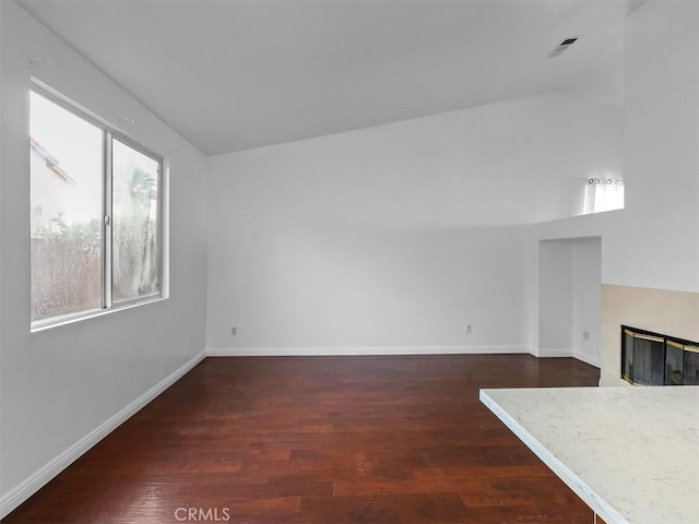 37453 56th St E, Palmdale, CA 93552 - unfurnished living room featuring a glass covered fireplace and dark wood-style flooring