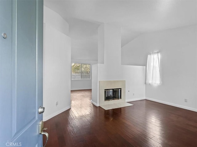 37453 56th St E, Palmdale, CA 93552 - unfurnished living room featuring hardwood / wood-style flooring, a fireplace with flush hearth, and lofted ceiling