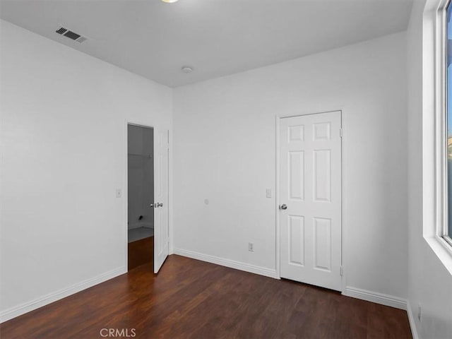 37453 56th St E, Palmdale, CA 93552 - unfurnished bedroom with dark wood-style flooring and baseboards