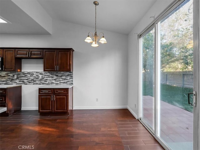 37453 56th St E, Palmdale, CA 93552 - kitchen featuring dark wood-type flooring, lofted ceiling, dark brown cabinetry, backsplash, and a chandelier