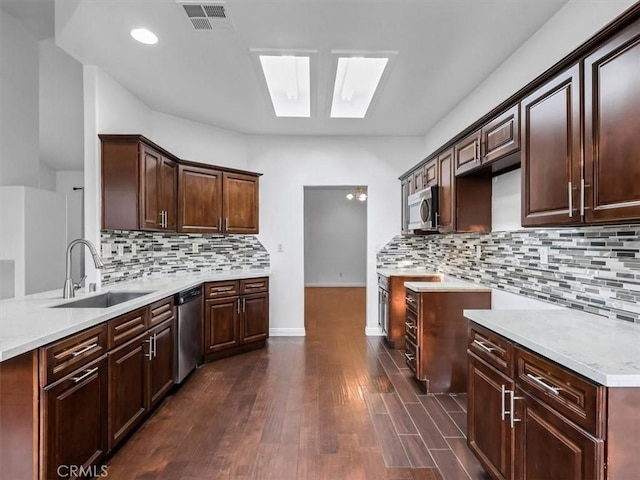 37453 56th St E, Palmdale, CA 93552 - kitchen featuring stainless steel appliances, dark wood-type flooring, light countertops, decorative backsplash, and dark brown cabinets
