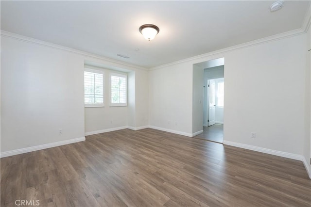 23 Bower Tree, Irvine, CA 92603 - unfurnished room featuring healthy amount of natural light, a smoke detector, crown molding, and wood finished floors