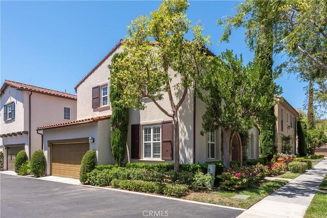 23 Bower Tree, Irvine, CA 92603 - view of front of house featuring a garage, stucco siding, and a tiled roof