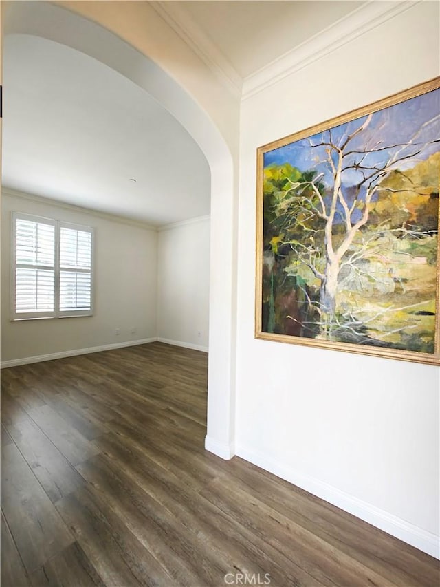23 Bower Tree, Irvine, CA 92603 - empty room with arched walkways, dark wood-type flooring, and crown molding