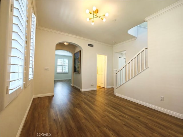 23 Bower Tree, Irvine, CA 92603 - empty room with arched walkways, wood finished floors, a chandelier, crown molding, and stairs