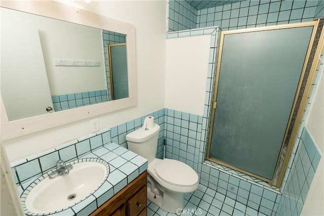 906 E 22nd St, Merced, CA 95340 - full bathroom featuring tile walls, a shower stall, vanity, wainscoting, and tile patterned floors