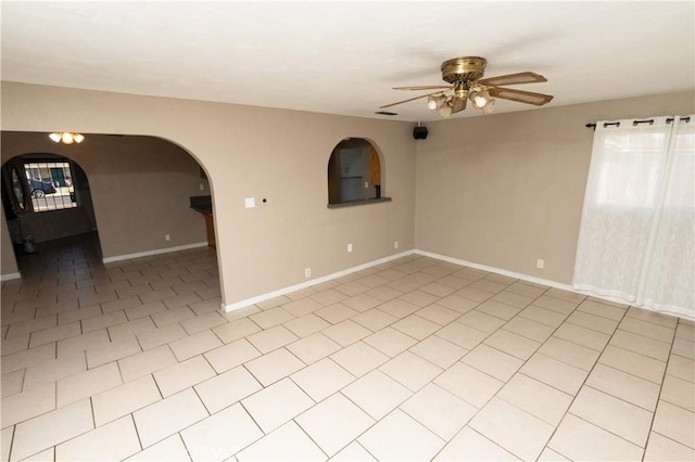 906 E 22nd St, Merced, CA 95340 - empty room with a ceiling fan, light tile patterned flooring, and arched walkways