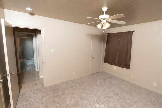 906 E 22nd St, Merced, CA 95340 - carpeted empty room featuring a smoke detector, ceiling fan, a textured ceiling, and tile patterned flooring