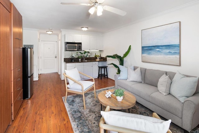 1021 Scott St Unit 130, Point Loma, CA 92106 - living area with wood finished floors, crown molding, and a ceiling fan