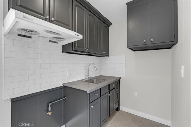 501 W Floral Dr, Monterey Park, CA 91754 - kitchen with under cabinet range hood, backsplash, and light tile patterned flooring
