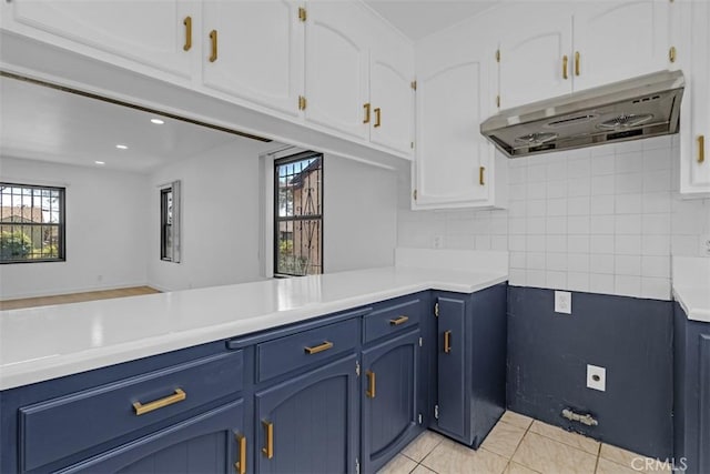501 W Floral Dr, Monterey Park, CA 91754 - kitchen featuring under cabinet range hood, blue cabinets, white cabinetry, light countertops, and light tile patterned floors