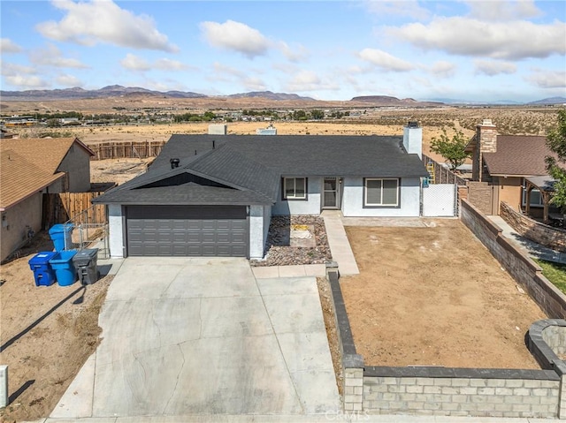 1233 Cabrillo Dr, Barstow, CA 92311 - single story home featuring a mountain view, a garage, driveway, and a shingled roof