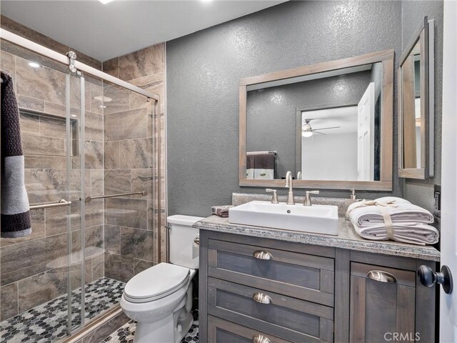 1233 Cabrillo Dr, Barstow, CA 92311 - full bath with a textured wall, ceiling fan, vanity, and a stall shower