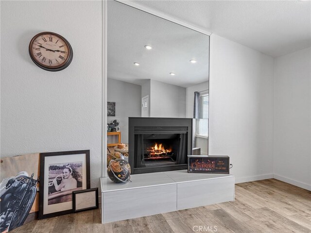 1233 Cabrillo Dr, Barstow, CA 92311 - living room with a multi sided fireplace, wood finished floors, and recessed lighting