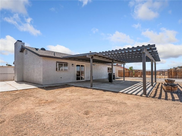1233 Cabrillo Dr, Barstow, CA 92311 - back of property featuring a pergola, stucco siding, a patio area, and a chimney