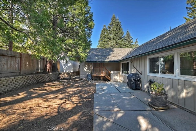 292 Heliotrope Dr, Lake Arrowhead, CA 92352 - view of property exterior with a patio area, roof with shingles, and board and batten siding