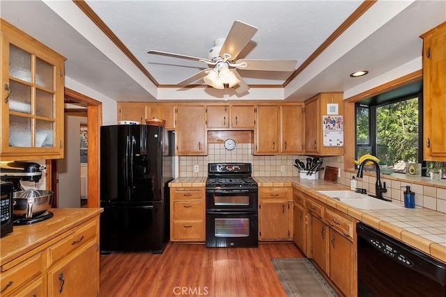292 Heliotrope Dr, Lake Arrowhead, CA 92352 - kitchen with black appliances, tile counters, a raised ceiling, wood finished floors, and crown molding