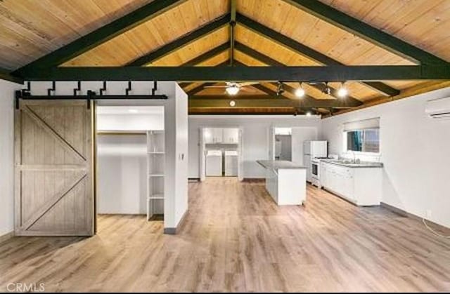 292 Heliotrope Dr, Lake Arrowhead, CA 92352 - kitchen with a barn door, light wood-style floors, wood ceiling, a wall unit AC, and fridge
