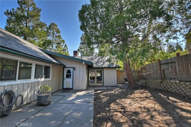 292 Heliotrope Dr, Lake Arrowhead, CA 92352 - rear view of house featuring a patio area, a fenced backyard, a chimney, and board and batten siding