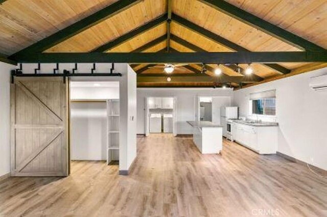 292 Heliotrope Dr, Lake Arrowhead, CA 92352 - kitchen featuring a barn door, wooden ceiling, light wood-type flooring, refrigerator, and a kitchen island