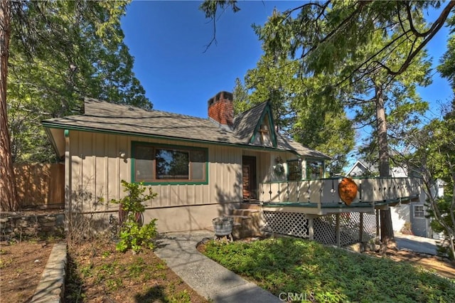 292 Heliotrope Dr, Lake Arrowhead, CA 92352 - view of front of house with a deck, a chimney, and board and batten siding