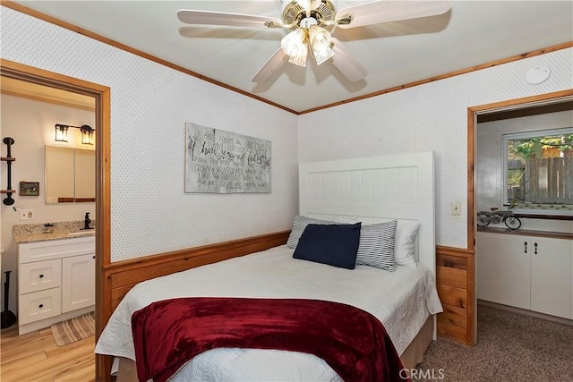 292 Heliotrope Dr, Lake Arrowhead, CA 92352 - bedroom with crown molding, wallpapered walls, ensuite bath, light wood-type flooring, and ceiling fan