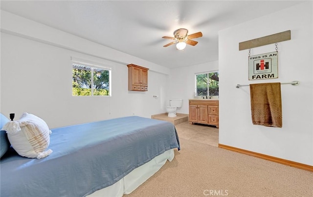 1785 Durham Dayton, Durham, CA 95938 - bedroom featuring multiple windows, light carpet, connected bathroom, and a ceiling fan