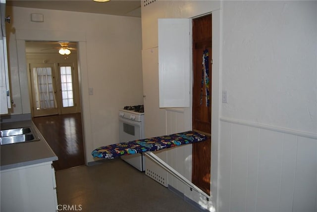4316 E Wehrle Ct, Long Beach, CA 90804 - kitchen featuring a ceiling fan, white range with gas cooktop, and a wainscoted wall