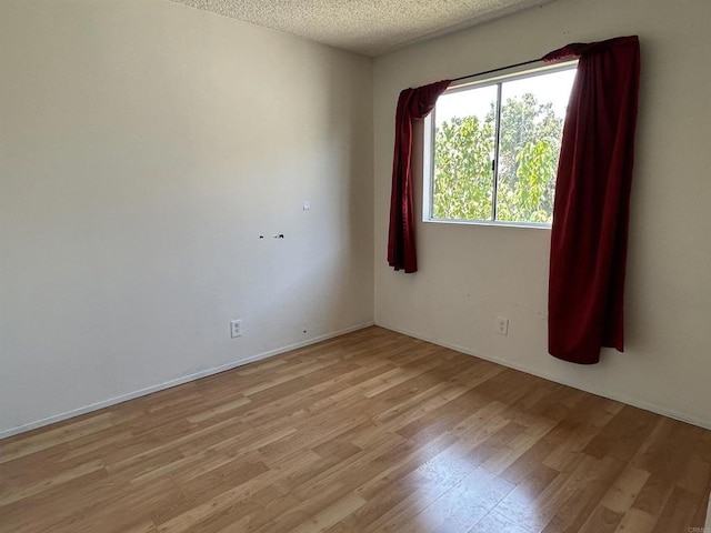 3010 Parkside Pl, San Diego, CA 92139 - unfurnished room with light wood-type flooring and a textured ceiling