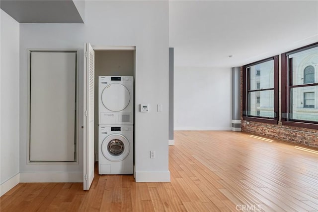 460 S Spring St Unit 1013, Los Angeles, CA 90013 - laundry area with stacked washer / drying machine and light wood-style flooring