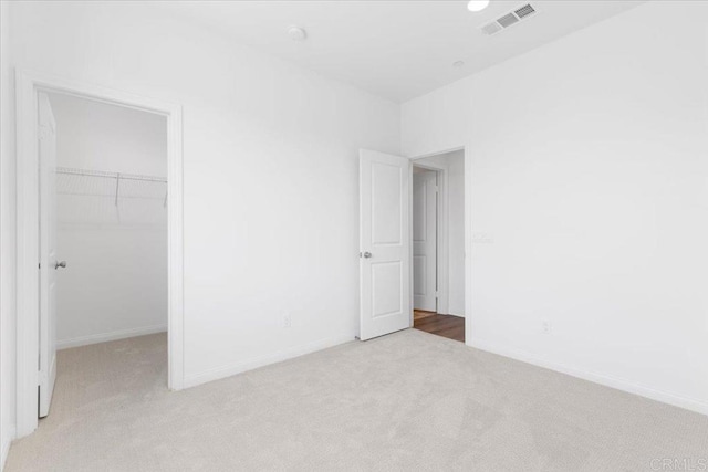 314 El Cajon Blvd, El Cajon, CA 92020 - unfurnished bedroom featuring light colored carpet, a spacious closet, and a closet