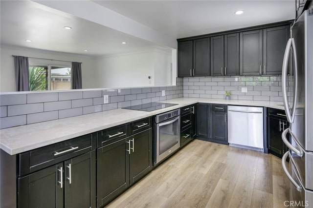 1319 E Monroe Ave, Orange, CA 92867 - kitchen featuring stainless steel appliances, backsplash, light wood-style floors, recessed lighting, and a peninsula