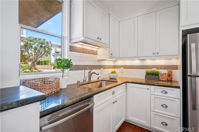555 Esplanade Unit 320, Redondo Beach, CA 90277 - kitchen with stainless steel appliances, white cabinets, backsplash, and dark stone counters