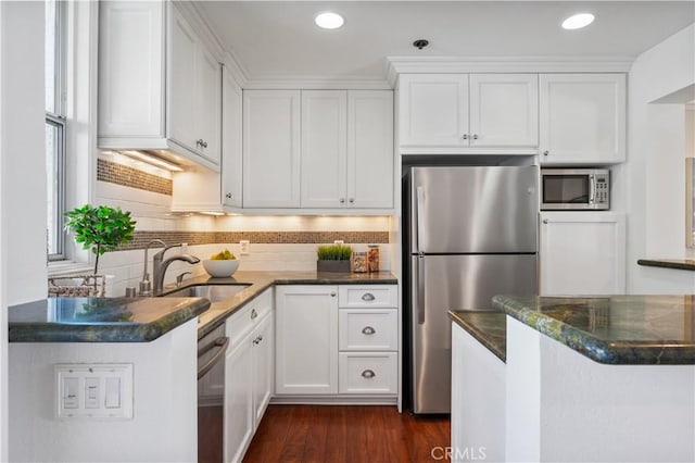 555 Esplanade Unit 320, Redondo Beach, CA 90277 - kitchen featuring appliances with stainless steel finishes, white cabinetry, dark wood finished floors, and recessed lighting