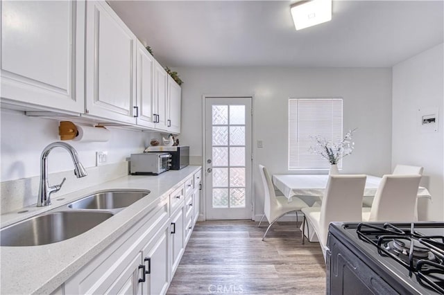 4430 W 166th St, Lawndale, CA 90260 - kitchen featuring white cabinets, light wood-style flooring, and black gas range
