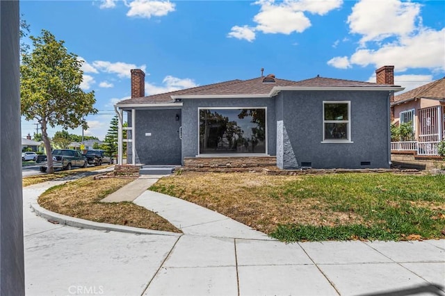 313 S Pickering Way, Montebello, CA 90640 - view of front of home with stucco siding, crawl space, a front lawn, and a chimney