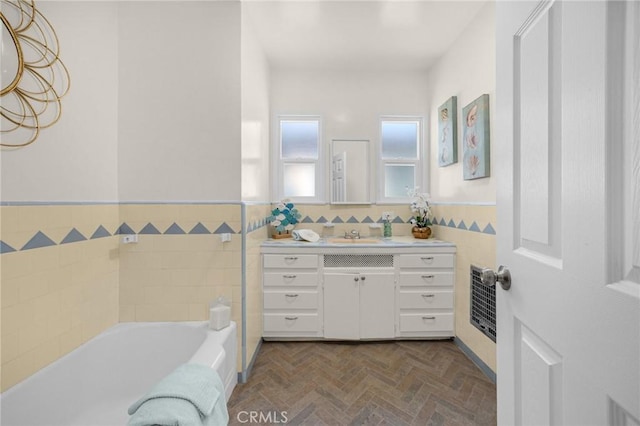 313 S Pickering Way, Montebello, CA 90640 - bathroom featuring a tub to relax in, vanity, a wainscoted wall, tile walls, and heating unit