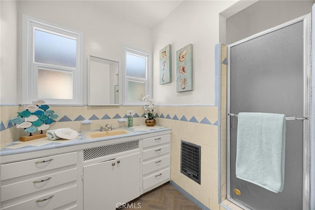 313 S Pickering Way, Montebello, CA 90640 - full bath featuring vanity, a stall shower, wainscoting, and tile walls