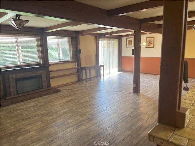 28957 Glen Oaks Dr, Menifee, CA 92586 - unfurnished living room with a wainscoted wall, beam ceiling, wood finished floors, and a fireplace