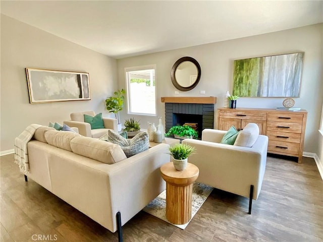 22801 Nolan St, Lake Forest, CA 92630 - living area featuring wood finished floors and a brick fireplace