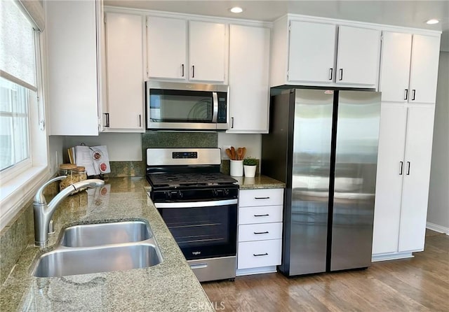 22801 Nolan St, Lake Forest, CA 92630 - kitchen with appliances with stainless steel finishes, white cabinetry, wood finished floors, and recessed lighting