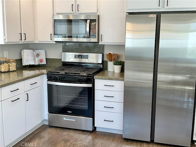 22801 Nolan St, Lake Forest, CA 92630 - kitchen with stainless steel appliances, white cabinets, dark wood-style floors, and dark stone counters