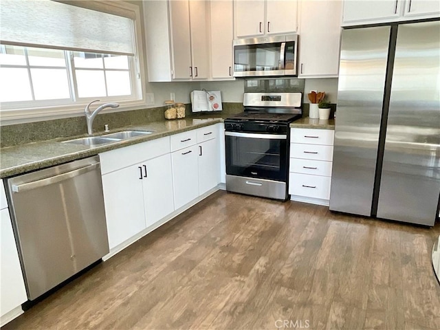 22801 Nolan St, Lake Forest, CA 92630 - kitchen with stainless steel appliances, dark wood-type flooring, white cabinets, and dark countertops